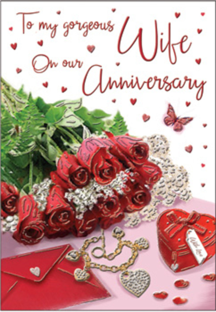 This anniversary card image is composed like a tender still life, reminiscent of a thoughtfully arranged gift waiting on a bedside table in a Catford home, with gentle daylight spilling across every detail. At the centre is a lush gathering of classic red roses, each bloom fully open and wonderfully full, their velvety petals swirling inward like little spirals of colour. The roses are surrounded by sprigs of fresh greenery, the leaves adding texture and a soft, natural frame, evoking the sensation of a bouquet just picked up from a local Catford florist after a stroll by Mountsfield Park. Nearby lies a cream-toned envelope, slightly angled, its surface smooth and inviting, hinting at an affectionate handwritten message tucked inside for a partner or spouse. Just beside it, a small, heart-shaped box in a deep, romantic red rests like a treasured keepsake, its curves smooth and gently reflective. A piece of jewellery-perhaps a delicate necklace or bracelet-glints in the light, its metallic shimmer echoing the excitement of exchanging gifts and marking another year together. Tiny heart shapes are scattered across the design, some printed, some with a hint of sparkle, drawing the eye across the card in a playful rhythm. A single butterfly motif hovers lightly at the edge of the flowers, suggesting movement and a touch of magic, as though love is still taking flight even after many shared milestones. The entire arrangement feels carefully composed and deeply personal, as if an experienced Catford Flowers designer has translated the emotion of an anniversary bouquet into an image that holds the scent of roses, the promise of a keepsake, and the warmth of enduring affection.
